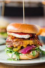 Juicy american hamburger with cheese, grilled ground meat, toppings