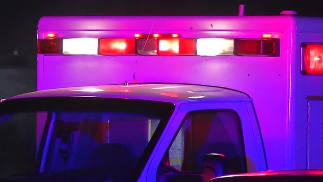 AMBULANCE WITH FLASHING EMERGENCY LIGHTS