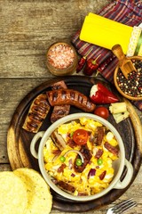 Scrambled egg with grilled sausage. Protein diet. A generous breakfast. Food preparation.