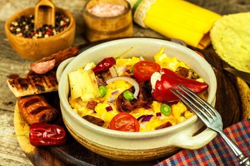 Scrambled egg with grilled sausage. Protein diet. A generous breakfast. Food preparation.