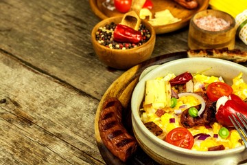 Scrambled egg with grilled sausage. Protein diet. A generous breakfast. Food preparation.