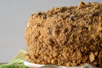 Sweet tasty cake sprinkled with nuts side view