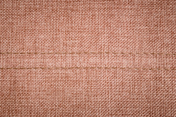 Textured background surface of textile upholstery furniture close-up. burlap brown Color fabric structure