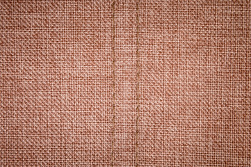 Textured background surface of textile upholstery furniture close-up. burlap brown Color fabric structure