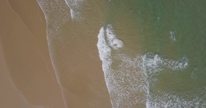 Sea aerial view, top view, amazing nature background. Blue of the water and beautiful sand coasline. Azure beach with turquoise waves and clear water of ocean at sunny day. Sea view from flying drone