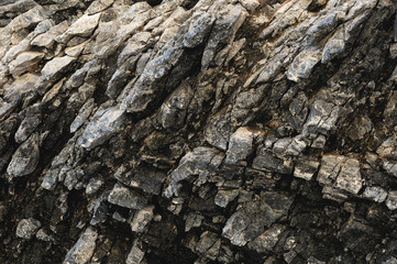 Textured basalt background thin stone fibers in the cut. natural volcanic formations