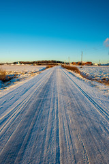 snow covered winter road with tire tracks