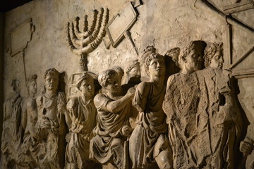 Wall relief on arch of titus depicting Menorah taken from temple in Jerusalem in 70 AD - Israel history, Jewish war - obrazy, fototapety, plakaty