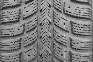 Close-up winter tire tread. Textured tire tread. Part of brand new modern winter car tire.