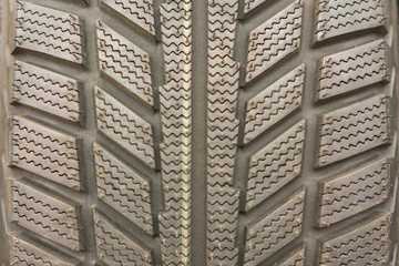 Close-up winter tire tread. Textured tire tread. Part of brand new modern winter car tire.