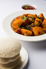 Masala fried Idlies or Idli fry - south indian Snack made using with leftover idly served with tomato ketchup. selective focus
