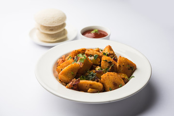 Masala fried Idlies or Idli fry - south indian Snack made using with leftover idly served with tomato ketchup. selective focus