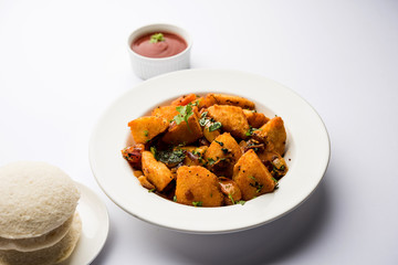 Masala fried Idlies or Idli fry - south indian Snack made using with leftover idly served with tomato ketchup. selective focus