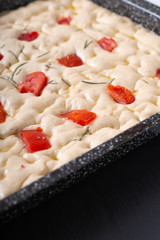 Food concept homemade organic focaccia dough in iron pan with copy space