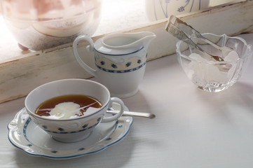East frisian tea time. Cup of hot tea served on a wodden table.