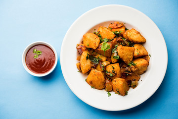 Masala fried Idlies or Idli fry - south indian Snack made using with leftover idly served with tomato ketchup. selective focus