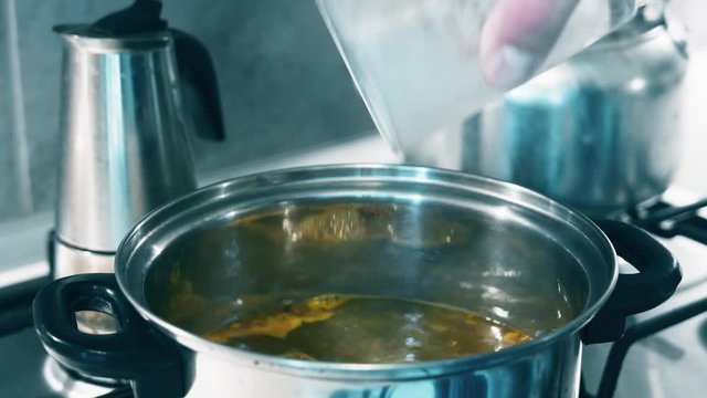 4K Pouring Instant Soup into Boiling Water in Metal Pot