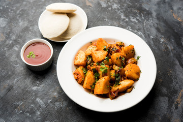 Masala fried Idlies or Idli fry - south indian Snack made using with leftover idly served with tomato ketchup. selective focus