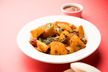 Masala fried Idlies or Idli fry - south indian Snack made using with leftover idly served with tomato ketchup. selective focus