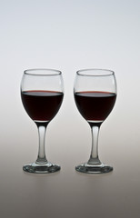 two glasses of red wine on the table 