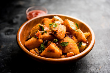 Masala fried Idlies or Idli fry - south indian Snack made using with leftover idly served with tomato ketchup. selective focus