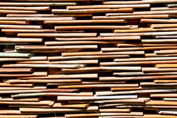 The texture of clay tiles stacked in rows