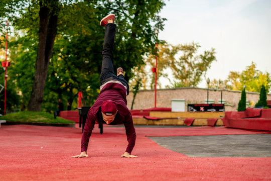 male athlete practising parkour in the street in summer day b