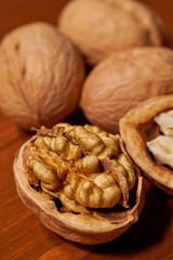 Walnut on brown wooden background. Selective focus