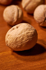 Walnut on brown wooden background. Selective focus
