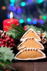 ginger biscuit  on brown background with Christmas tree ,  candles and christmas lights