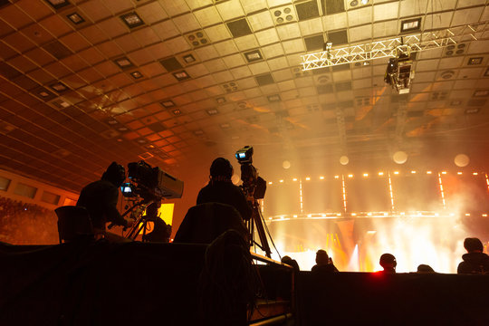 A group of cameramen working during the concert.