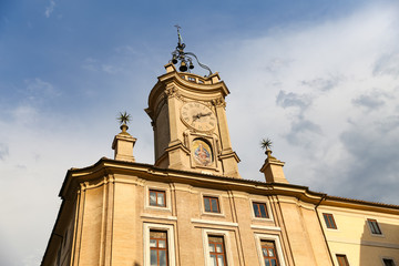 Fototapeta na wymiar Clock Tower over a Building in Rome, Italy