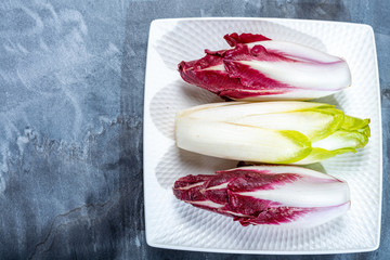 Food background, flat lay concept with fresh green Belgian endive or chicory and red Radicchio...