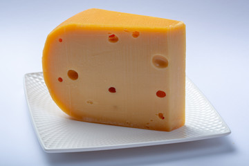 One piece of traditional Dutch old hard cheese made from cow milk