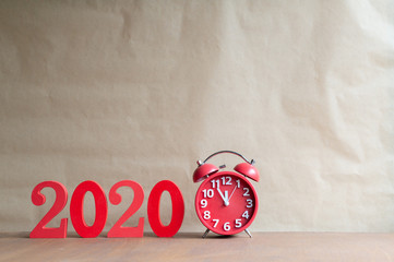 Happy New Year 2020 on a white background,On the right there is a alarm clock.