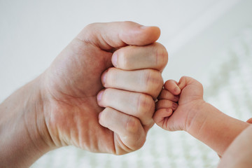 father fist bumping child