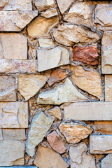 Close-up photo. Fragment of masonry wall with decorative stone trim.