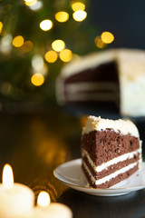 Chocolate cake with butter frosting and crushed nuts. Served on a porcelain plate, high resolution