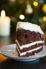Chocolate cake with butter frosting and crushed nuts. Served on a porcelain plate, high resolution