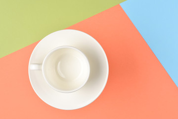 Empty cup on colorful background.