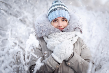 Beautiful smiling young woman in wintertime outdoor. Winter concept - obrazy, fototapety, plakaty