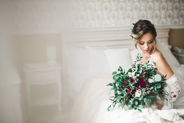 Portrait of beautiful bride with fashion veil at wedding morning