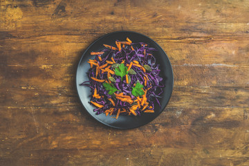 Obraz na płótnie Canvas Salad of purple cabbage, carrots pumpkin seeds and parsley