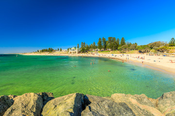 Cottesloe Beach in Western Australia: white sand and calm turquoise waters. The Perth's most famous beach, Indian Ocean. Summertime in blue sky. Copy space.