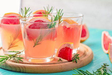 Fresh pink alcoholic cocktail with grapefruit, ice and rosemary