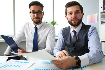 Group of businessmen with financial graph and silver pen