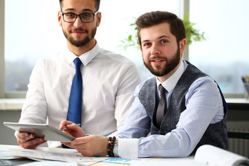 Group of businessmen point finger and silver pen in arms