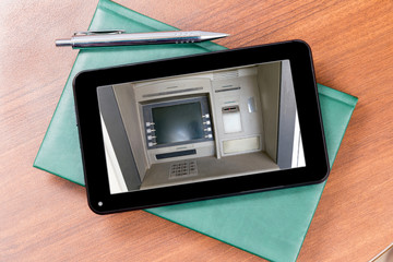ATM on the screen of the tablet. Diary and fountain pen