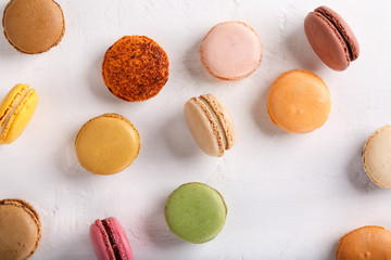 Sweet macarons on white background. Different multi-colored macaroon cookies. colorful almond cookies, french sweet delicacy. Food background.