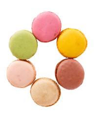 Letter O from multi-colored macaroon cookies. Flat lay, top view, isolated on white.